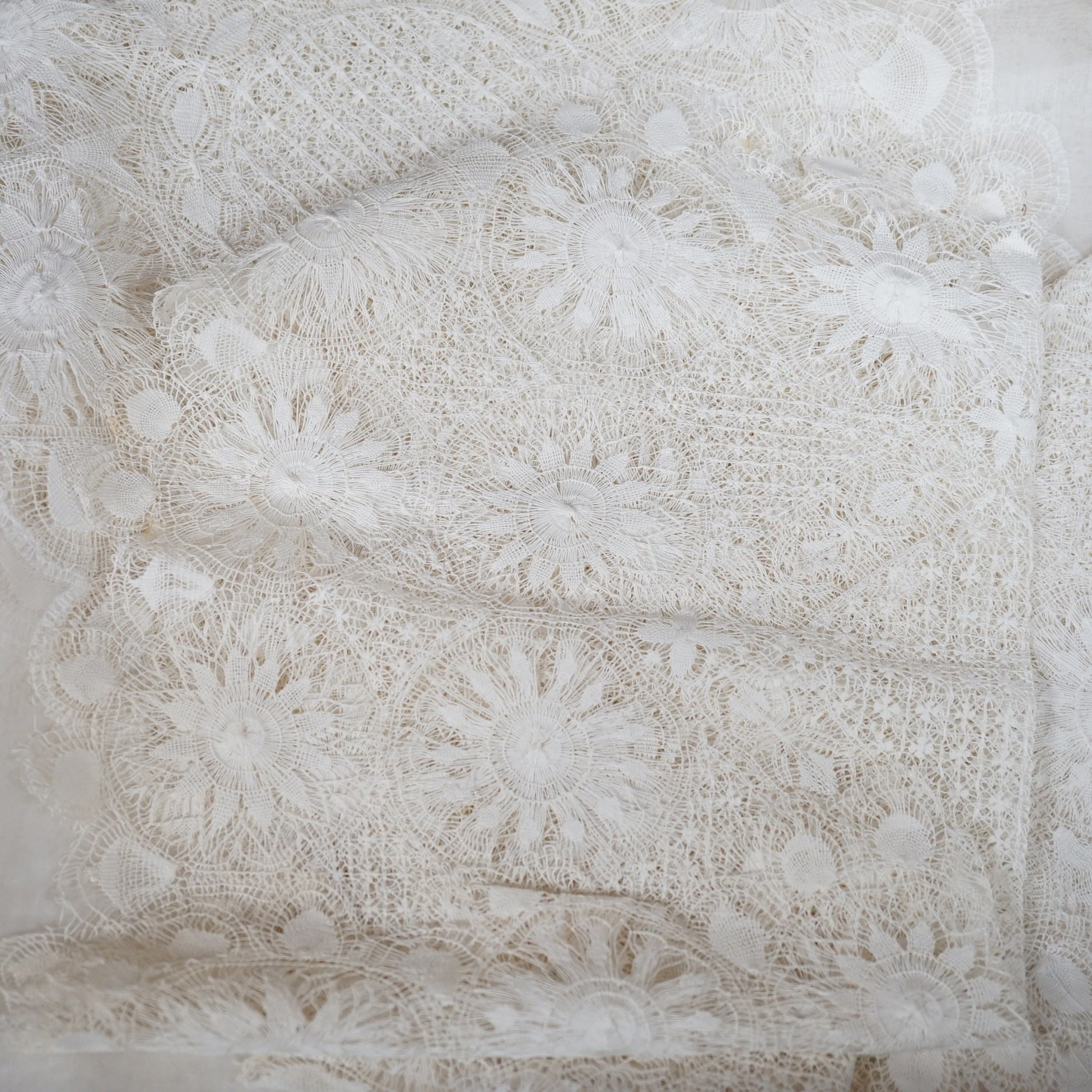 A collection of hand made finely worked tatting lace table linen, including cloths mats and napkins